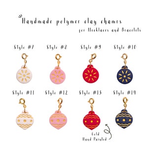 May include: Eight gold-tone charm pendants with hand-painted polymer clay ornaments in various colors and designs. The ornaments are shaped like Christmas ornaments and feature a gold-tone snowflake design. The charms are labeled "Style #7" through "Style #14".