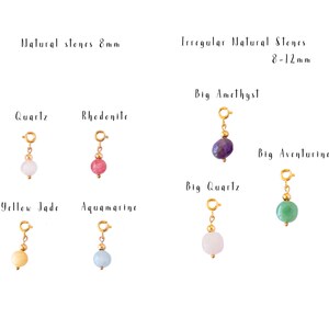 May include: Assortment of natural stone charms for jewelry making.  The charms are made with various stones, including quartz, rhodonite, yellow jade, aquamarine, amethyst, aventurine, and quartz.  The stones are available in two sizes: 8mm and 8-12mm.