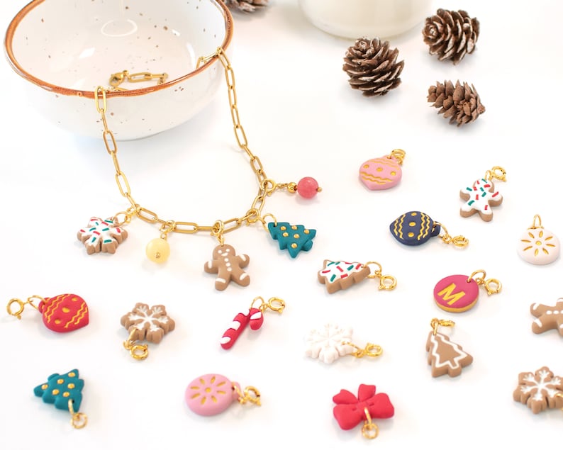 Custom Christmas multi-charm necklace with various holiday-themed charms including a gingerbread man, a Christmas tree, a snowflake, a candy cane, and more on a gold chain, available on Etsy.
