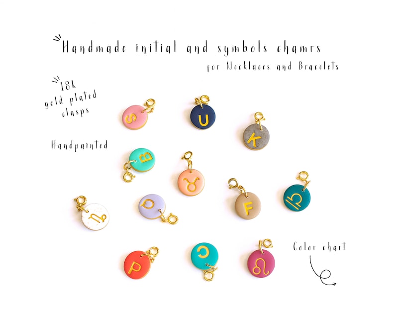 May include: Assortment of handmade initial and symbol charms for necklaces and bracelets. The charms are made of polymer clay and feature gold-plated clasps. The charms are hand-painted with various colors and designs, including letters, zodiac signs, and other symbols.