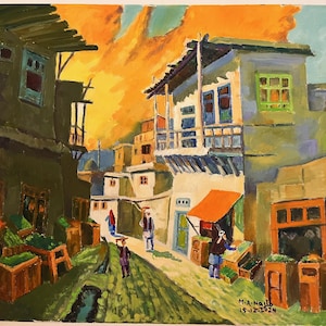 May include: A colorful painting depicting a narrow street in a Middle Eastern city. The buildings are painted in shades of green, blue, and white, with orange and yellow accents. The street is lined with shops and stalls, and there are people walking around. The sky is a vibrant orange and yellow, and there are clouds in the sky. The painting is signed "M.A.Najib 15-12-1924".