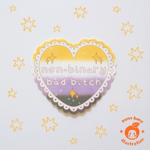 May include: A heart-shaped sticker with a non-binary pride flag design. The sticker features the text "non-binary bad bitch" in a whimsical font. The sticker is surrounded by a scalloped border and star accents, with additional star doodles on a white background.