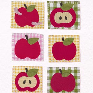 May include: Six square fabric patches featuring apple designs. Three patches show whole red apples, two show sliced apples with seeds, and one shows a whole apple with a worm. The patches have gingham backgrounds in yellow, green, and pink with white stitching.