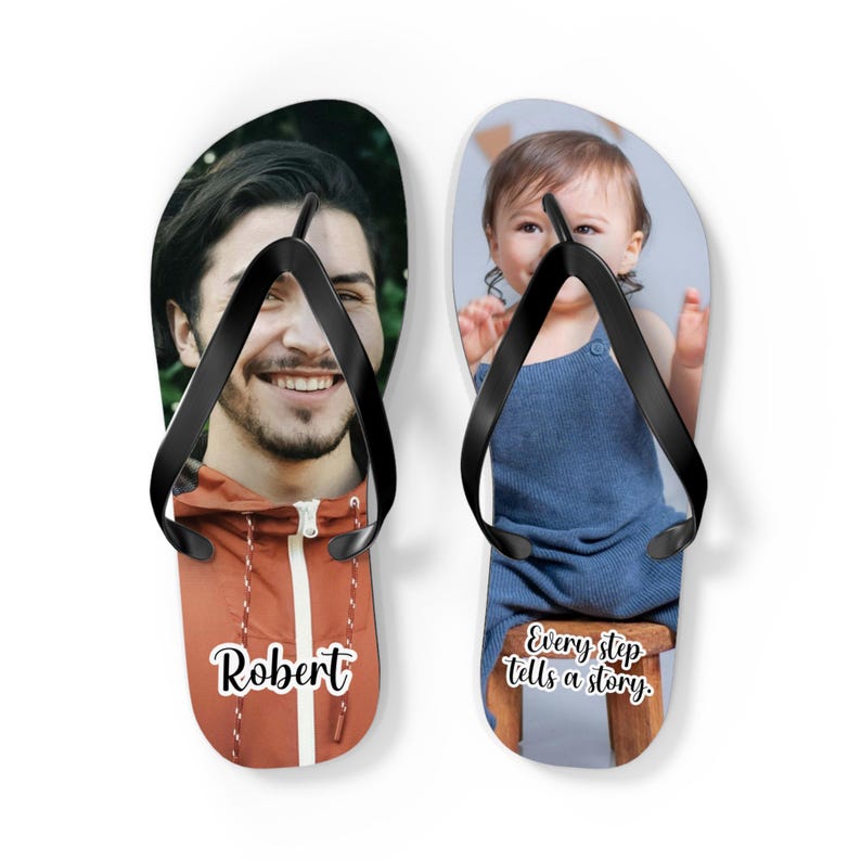 May include: A pair of custom flip-flops with black straps. The left sandal features a photograph of a man in an orange jacket with the name Robert printed below. The right sandal displays a photograph of a child with the text Every step tells a story.