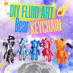 May include: Five colorful bear keychains with a marbled paint design. The bears are black and white, red and white, blue and white, orange and white, and green and white. The keychains are hanging from a white background with the text "DIY FLUID ART Bear KEYCHAIN" in yellow and blue letters.