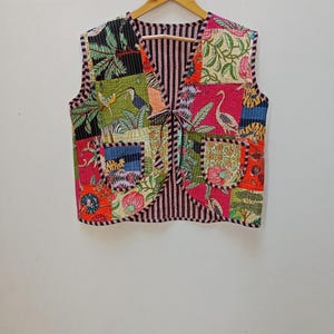 May include: A sleeveless vest made of patchwork fabric with a variety of colorful floral and animal prints. The vest has a V-neck and a tie closure at the front.