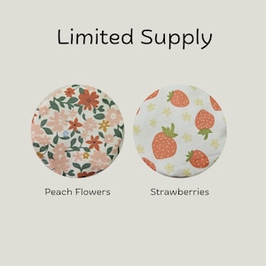 May include: Two circular fabric covers labeled Limited Supply. The left cover features a pattern of peach, orange, and green flowers. The right cover displays a pattern of red strawberries and small yellow flowers labeled Strawberries.