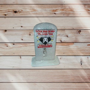 May include: A white glitter resin figurine with a red and black graphic that says "I can see right through you. What's your super power?" with a silver charm hanging from the bottom.