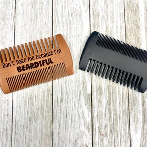 May include: Two beard combs, one wooden with the text "Don't hate me because I'm beardful" and one black plastic.