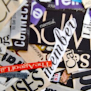 May include: A close-up of a collage of words and phrases cut from magazines and newspapers. The words include "remember", "discount", "religion", "houses", "pushed", "the past", "you", and "city".