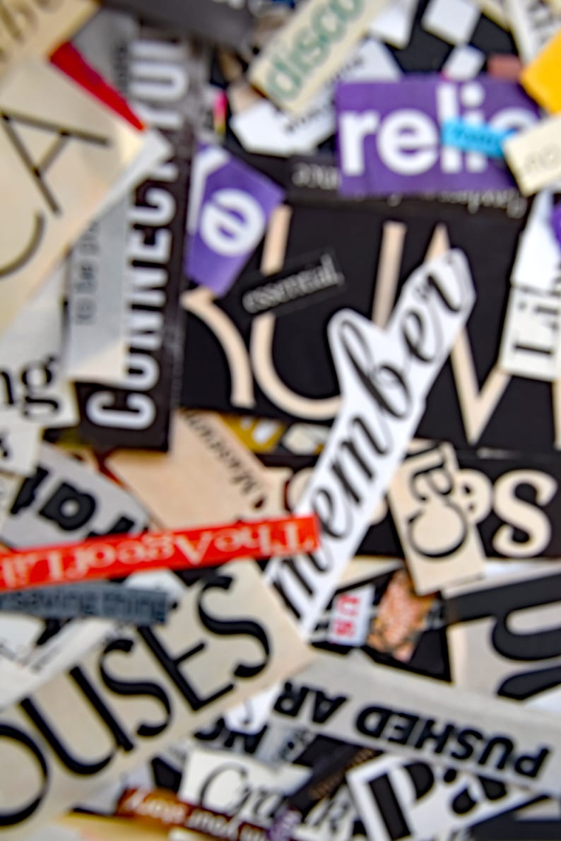 May include: A close-up of a collage of words and phrases cut from magazines and newspapers. The words include "remember", "discount", "religion", "houses", "pushed", "the past", "you", and "city".