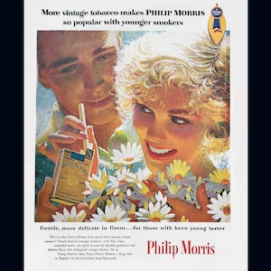 May include: Vintage advertisement for Philip Morris cigarettes. The image features a couple surrounded by flowers, with the woman smiling. The text reads "More vintage tobacco makes Philip Morris so popular with younger smokers."