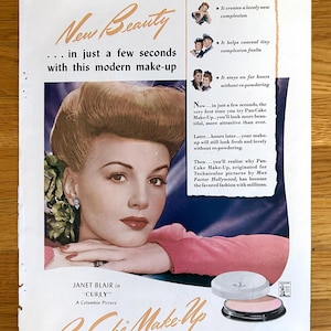 May include: Vintage advertisement for Pan-Cake Make-Up by Max Factor Hollywood. The ad features a woman with styled hair and makeup, with text promoting the product's benefits. The makeup compact is visible.