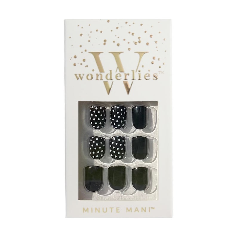 May include: A white rectangular box labeled wonderlies and MINUTE MANI containing nine press-on nails. The set features a mix of solid black nails and black nails with a white polka dot pattern arranged in a three-by-three grid display.
