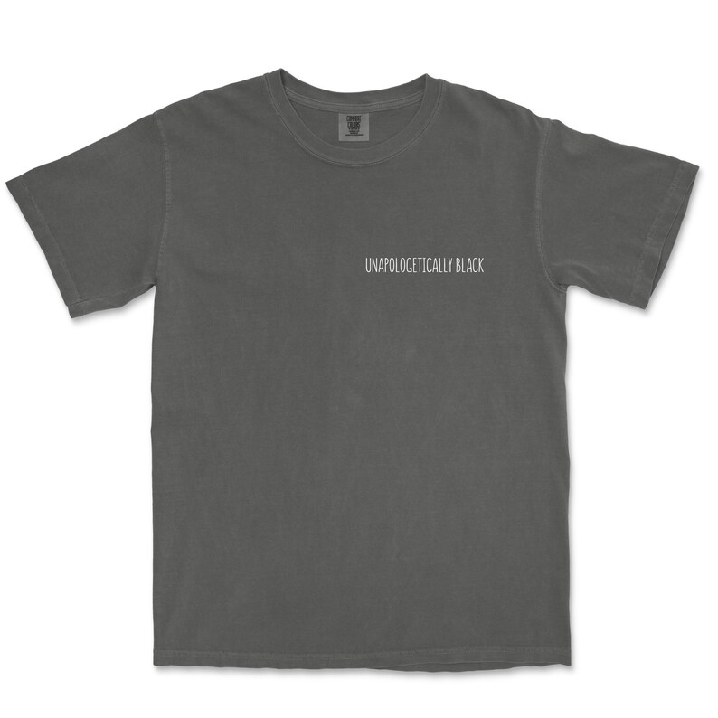 May include: A charcoal gray t-shirt with the text "Unapologetically Black" printed on the front.