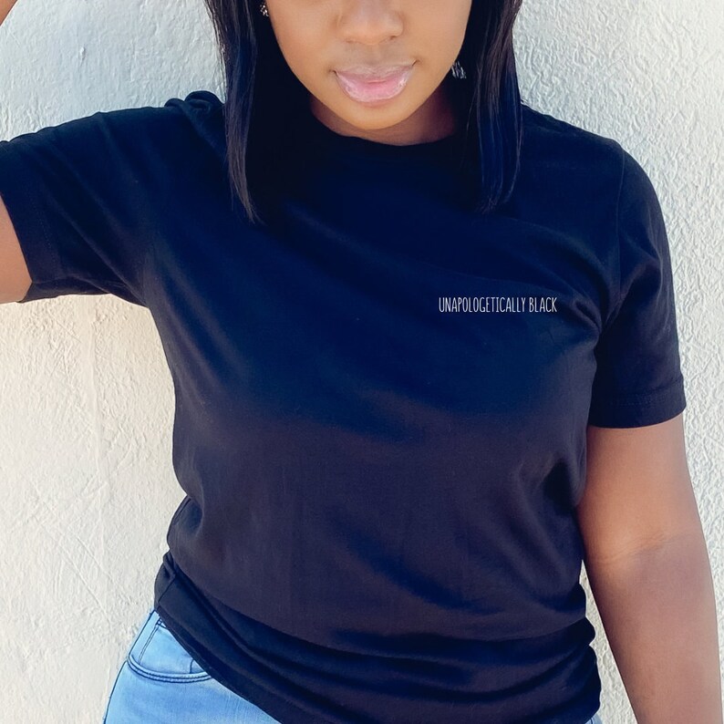 May include: A black t-shirt with the text "Unapologetically Black" printed on the front.