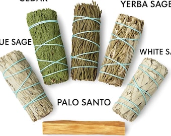 May include: A set of six smudge sticks, including cedar, juniper, yerba sage, white sage, blue sage, and palo santo. The sticks are tied with blue string and arranged in a semi-circle on a white background. A piece of palo santo wood is also included.