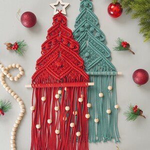 May include: Two macrame Christmas tree wall hangings, one red and one teal, with wooden beads and a star at the top.