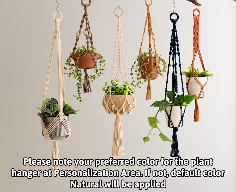 May include: Five macrame plant hangers with different colored cords and wooden beads. The hangers are holding small potted plants. The text "Please note your preferred color for the plant hanger at Personalization Area. If not, default color Natural will be applied" is at the bottom of the image.