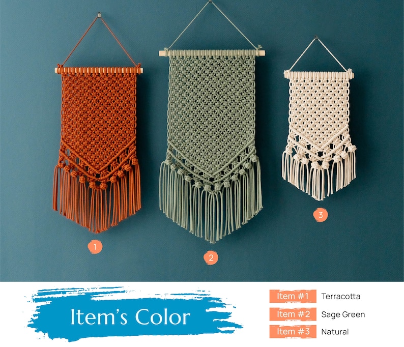 May include: Three macrame wall hangings in terracotta, sage green, and natural colors. The hangings are made with a knotted pattern and have fringe at the bottom.