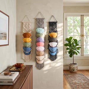 May include: A set of three ceramic canisters with lids. The canisters are white with a blue floral pattern. The largest canister is 8 inches tall, the medium is 7 inches, and the smallest is 6 inches.