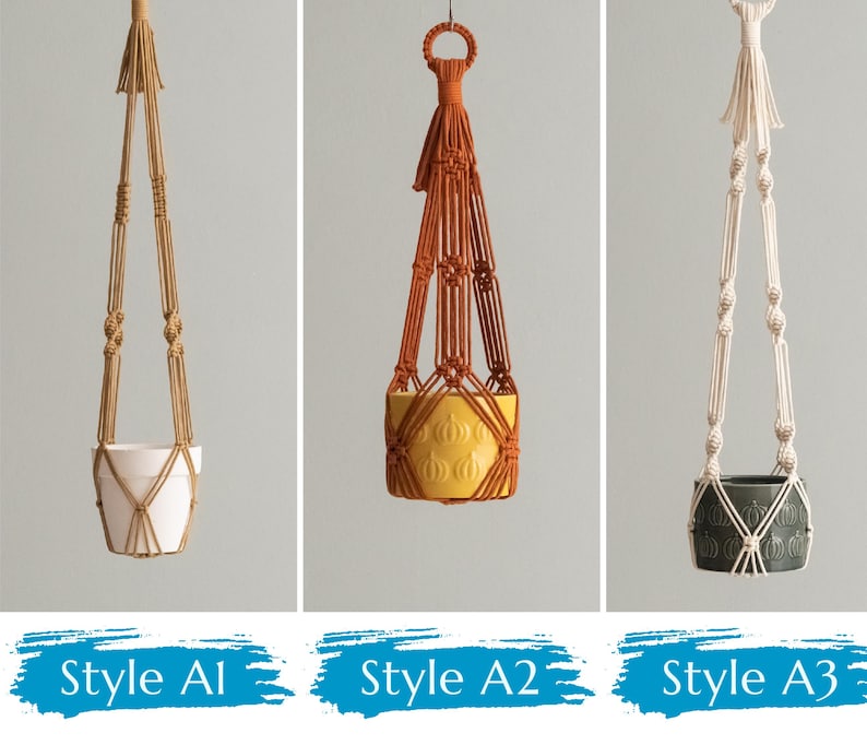 May include: Three macrame plant hangers with different styles. The first is a natural color with a white pot. The second is orange with a yellow pot. The third is white with a dark green pot.