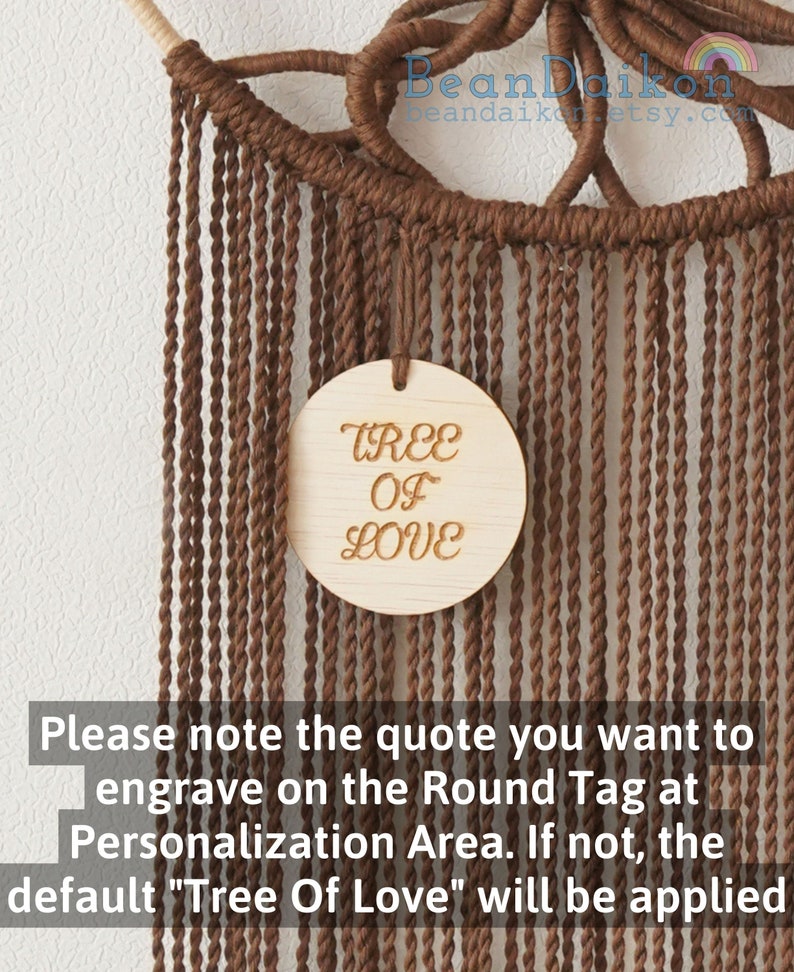 May include: A brown macrame wall hanging with a round wooden tag that says "TREE OF LOVE".