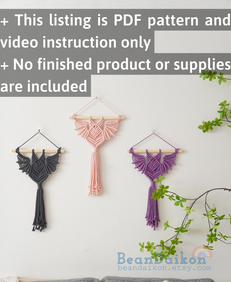 May include: Three macrame wall hangings in the shape of a bat with tassels. The hangings are in shades of grey, pink, and purple. The text "BeanDaikon beandaikon.etsy.com" is at the bottom of the image.