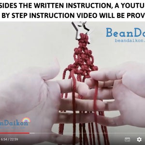 May include: A close-up of a person's hands demonstrating a macrame knotting technique. The red cords are tied together in a complex pattern, creating a decorative piece. The image includes the text "BeanDaikon" and a website address.