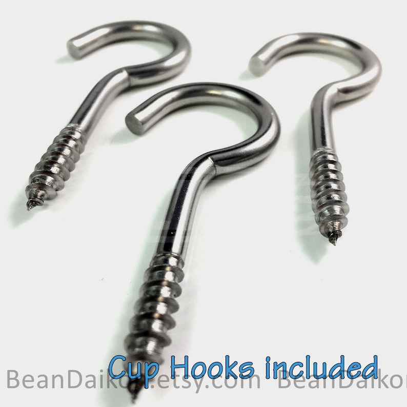 May include: Three silver screw-in cup hooks. The hooks are made of metal and have a shiny finish. The hooks are designed to be screwed into a surface, such as a wall or shelf.