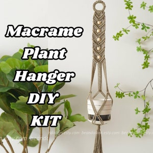 May include: A DIY macrame plant hanger kit with natural beige cord and wooden beads. The kit includes everything you need to create a hanging planter for your home decor.