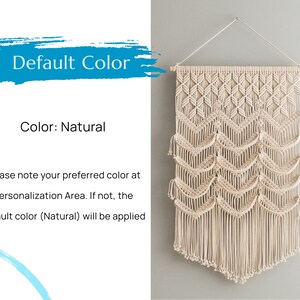 May include: A natural-colored macrame wall hanging with a geometric pattern. The hanging is made of cotton cord and has a fringe at the bottom. "Default Color: Natural" and "Color: Natural" are written in text on the image.