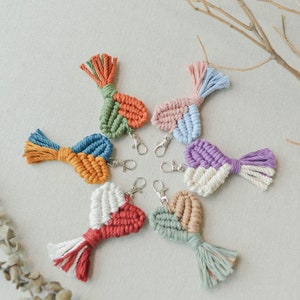 May include: Seven colorful crocheted heart-shaped keychains with tassels. Each keychain is made with different colored yarn and has a silver key ring.