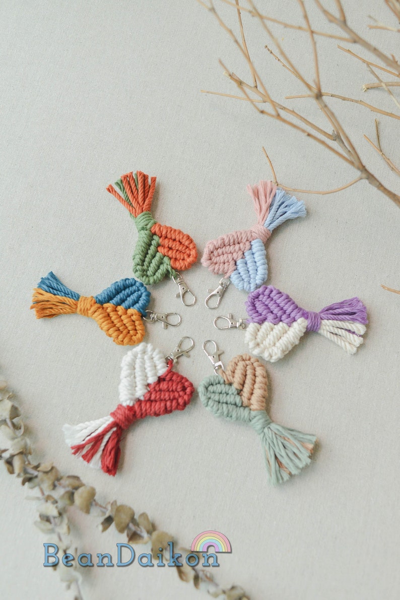 May include: Seven colorful crocheted heart-shaped keychains with tassels. Each keychain is made with different colored yarn and has a silver key ring.