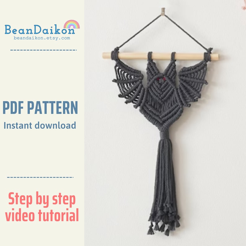 May include: A grey macrame bat wall hanging with a wooden dowel at the top and a long tassel at the bottom. The bat has red eyes. The text "PDF PATTERN Instant download" and "Step by step video tutorial" is visible in the image.