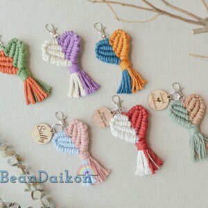 May include: A set of colorful heart-shaped keychains with tassels. Each keychain has a wooden tag with a name on it. The names on the tags are Sally, Joseph Stephanie, and  Princeton August 2023.