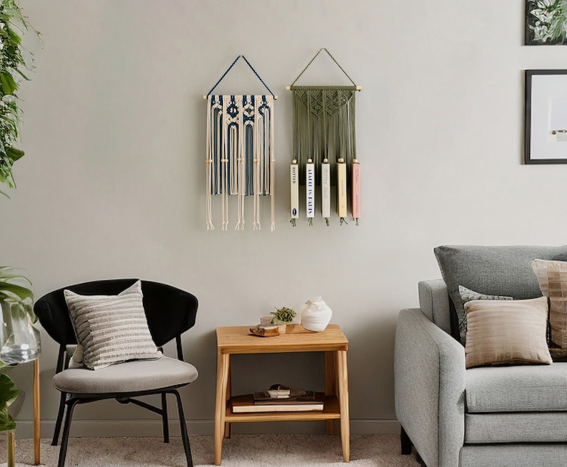 May include: Two macrame wall hangings, one blue and white, the other green, with books displayed on the green one.