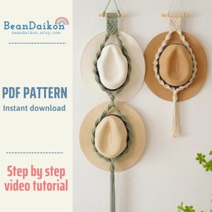 May include: Three straw hats hanging on a wall using a macrame hat rack. The hat rack is made with natural coloured cord and has a green tassel. The hats are in different colours and sizes. The text "PDF PATTERN Instant download" and "Step by step video tutorial" is visible on the image.