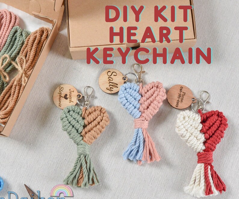 May include: DIY kit to make a heart-shaped keychain. The kit includes colorful string, wooden beads, and a metal ring. The finished keychain is shown in three different colors: green and brown, blue and pink, and white and red.
