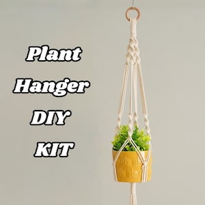 May include: DIY plant hanger kit with a white macrame rope and a yellow pot with a green plant.