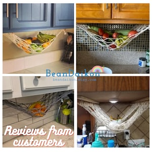 May include: Four images showing a white cotton rope hammock hanging from kitchen cabinets and holding various fruits and vegetables. The text "BeanDaikon" and "beandaikon.etsy.com" is visible in the image. The text "Reviews from customers" is visible in the image.