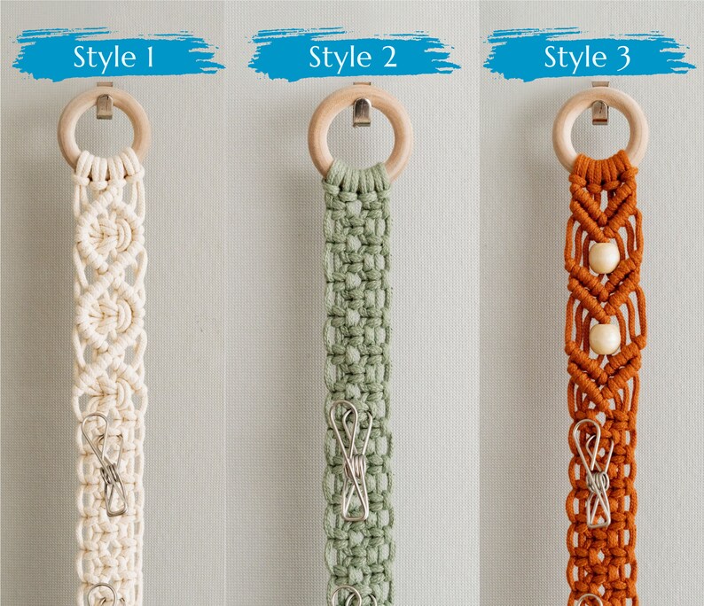 May include: Three macrame wall hangings with wooden rings and metal clips. Styles include off-white, sage green, and burnt orange. Each has a unique woven design and metal clips for displaying items. Text above each reads "Style 1", "Style 2", and "Style 3".