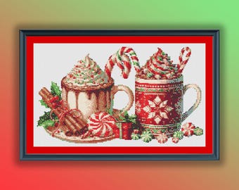 May include: Two mugs of hot chocolate with whipped cream and candy canes, surrounded by candy canes, cinnamon sticks, and green holly leaves.