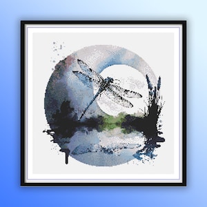 May include: A black and white cross stitch pattern of a dragonfly flying in front of a moon with a watercolor background.