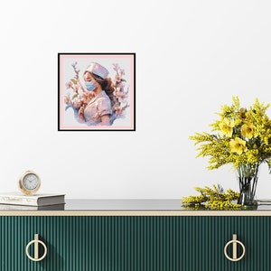 May include: A framed painting of a woman wearing a white nurse's uniform and a blue face mask. She is surrounded by pink flowers. The painting is on a white wall above a green dresser with gold handles.
