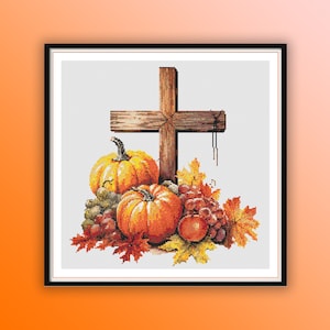 May include: A wooden cross with a fall harvest theme. Pumpkins, grapes, and fall leaves surround the base of the cross.