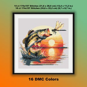 May include: Framed cross-stitch depicting a leaping bass with a dragonfly against a sunset. The artwork details include stitch counts and sizes: 14 ct (31.6 x 28.5 cm) and 18 ct (24.6 x 22.2 cm). The design uses 16 DMC colours.