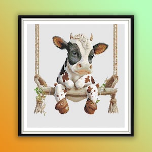 May include: A black and white cow with brown spots sits on a wooden swing with green vines. The cow is looking down and has a sad expression. The swing is made of rope and has a wooden seat.