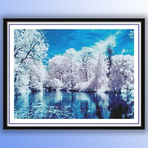 May include: A painting depicting a winter scene with a lake and trees covered in snow. The sky is blue and the water is a deep blue. The trees are white and the snow is white.