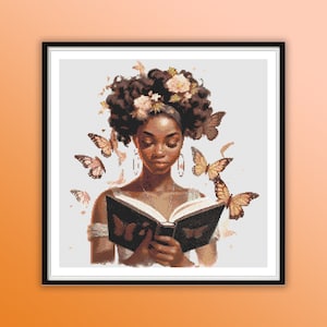 May include: A painting of a Black woman with brown curly hair wearing a floral crown and reading a book. Butterflies are flying around her head.